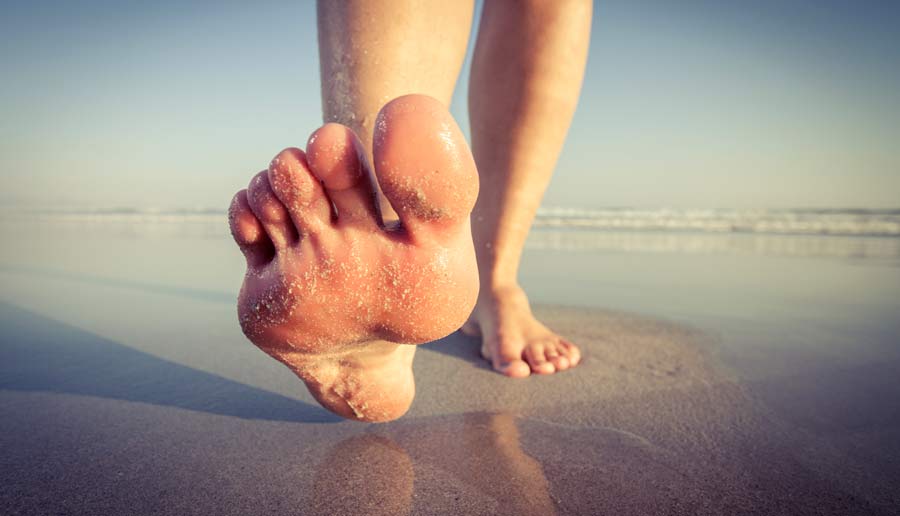 Feet walking a mile on beach