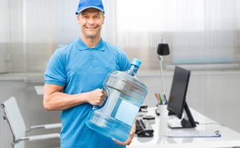 Man carrying a gallon of water