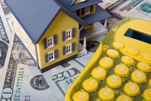 Mortgage refinancing - house, calculator and dollar note